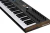 A close-up, angled view of a black Arturia KeyLab 61 mk3 MIDI keyboard with wood accents on the sides. Produktbild-Vorschau