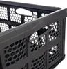 A close-up view of the side of a dark gray foldable storage crate. Produktbild-Vorschau