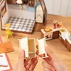Hands assembling a miniature dollhouse kitchen. Náhľad obrázku produktu
