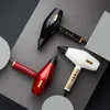 Three hairdryers are arranged diagonally on a gray and black background. Anteprima dell’immagine prodotto