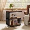 A narrow side table with three shelves is placed next to a brown leather armchair in a room with blinds. Produktbild-Vorschau