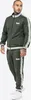 A man wearing a green tracksuit with white stripes on the sleeves and legs. Náhled obrázku produktu