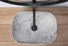 A top-down view of a stone sink with a black faucet on a wooden surface. Produktbild-Vorschau