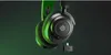 A pair of black and green gaming headphones with a USB dongle, presented against a dark green gradient background. Produktbild-Vorschau