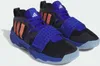 A pair of black and blue Adidas basketball shoes with orange stripes. Podgląd zdjęcia produktu
