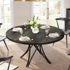A round dining table set for a meal in a dining room with large windows. Anteprima dell’immagine prodotto