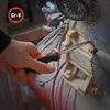 A hand is using a screwdriver to tighten a screw on a piece of machinery. Náhled obrázku produktu