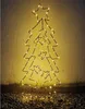 A wireframe Christmas tree decoration with lights, standing against a textured wall. Podgląd zdjęcia produktu