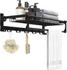 A black bathroom shelf with products and towels. Produktbild-Vorschau