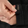 A close-up of a person's hand adjusting a black jacket sleeve. Produktbild-Vorschau