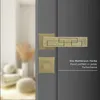A close-up of a door handle set on a gray door, with a blurred interior scene in the background. Produktbild-Vorschau