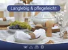 A table setting with white cloth napkins, grapes, and decorative mushroom-shaped napkin rings. Produktbild-Vorschau