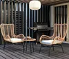 An outdoor patio setting with a grill, two chairs, and a small table. Náhled obrázku produktu