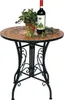 A mosaic-topped round table with a metal base, a potted plant, and a bottle of wine. Produktbild-Vorschau