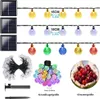A collage of solar-powered LED string lights in various colors and configurations, along with a close-up of cherries for size comparison. Náhled obrázku produktu