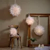 A room decorated with paper star lanterns, a chair, and candles. Podgląd zdjęcia produktu