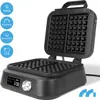 A black waffle maker is shown open, with its waffle plates visible. The waffle maker has an LCD screen and a dial on the front. Several blue circular icons with white text are displayed on the left side of the image. Náhľad obrázku produktu