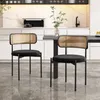 Two black velvet dining chairs with rattan backs are placed in a modern kitchen setting. Náhled obrázku produktu