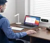 A person working at a desk with a laptop, keyboard, and USB hub. Náhled obrázku produktu