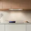 A modern kitchen scene with cabinetry, a stovetop, and cooking utensils. Voir les images du produit