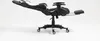 A black and white gaming chair with its footrest extended, shown on a white background. Produktbild-Vorschau