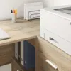 A close-up of a desk with a printer, binders, and office supplies. Náhled obrázku produktu