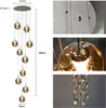 A collage of images showing a multi-light pendant lamp with glass globes, including close-ups of the fixture and a decorative crystal element. Produktbild-Vorschau