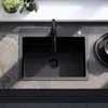 A black kitchen sink with a black faucet is shown on a stone countertop. Náhled obrázku produktu