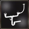 A white double sink drain assembly with stoppers and a P-trap is shown against a black background. Produktbild-Vorschau