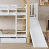 A close-up view of a white bunk bed with a slide and ladder, set against a lightly patterned wall. Náhled obrázku produktu