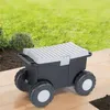 A garden cart with wheels is placed on a paved patio next to a grassy lawn and some bushes. Produktbild-Vorschau