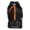 The back view of a black hiking shoe with orange accents. Produktbild-Vorschau