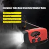 A red and black emergency radio with a flashlight is shown with a dark, smoky background and lightning effects. Text overlays highlight the product's features. Podgląd zdjęcia produktu