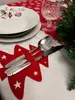 A Christmas-themed table setting with plates, cutlery, a glass, and a Christmas tree branch. Podgląd zdjęcia produktu