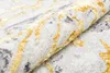 A close-up view of a rolled-up rug with a vintage-inspired pattern in gray and gold. Produktbild-Vorschau