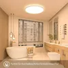 A modern bathroom with a bathtub, toilet, and vanity, featuring a ceiling light. Produktbild-Vorschau