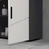 A close-up view of a bathroom cabinet with a white door and a dark gray side panel. Produktbild-Vorschau