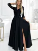 A woman wearing a black dress in a well-lit room. Anteprima dell’immagine prodotto