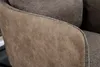 Close-up of the textured fabric and stitching on the armrest of a chair. Produktbild-Vorschau