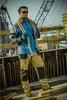 A construction worker stands on a building site holding a rope. Produktbild-Vorschau