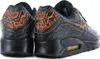 A pair of black Nike Air Max 90 QS sneakers with orange accents and detailing. Anteprima dell’immagine prodotto