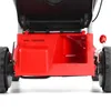 Close-up view of the rear of a red lawnmower, showing the wheels and the grass collection area. Produktbild-Vorschau