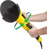 A person's hands are holding a yellow and black angle grinder with a cutting disc attached. Green arrows indicate rotation and a directional movement. Produktbild-Vorschau