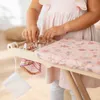 A child is playing with a toy ironing board. Podgląd zdjęcia produktu