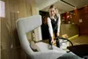 A woman is cleaning a chair with a cleaning machine in a hotel lobby. Produktbild-Vorschau