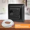 A black thermostat with a temperature dial and a coiled white cable are placed on a wooden surface, with a blurred interior background. Anteprima dell’immagine prodotto