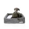 A dog is lying in a dog bed. Náhľad obrázku produktu