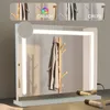 A makeup mirror with integrated LED lighting is displayed on a desk, with a coat hanging on a wooden rack reflected in the mirror. Anteprima dell’immagine prodotto