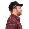 A man wearing a plaid shirt and a black cap with the "uvex" logo. Anteprima dell’immagine prodotto