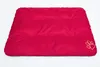 A red dog bed with a paw print logo on a white background. Náhľad obrázku produktu